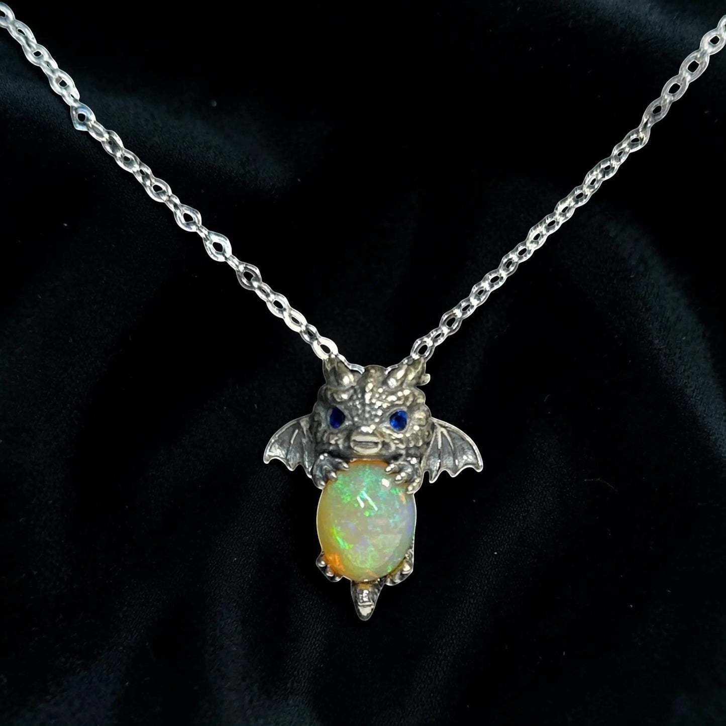 Celtic Dragon Jewellery baby dragon pendant in 925 sterling silver with vibrant opal and blue cz eyes.