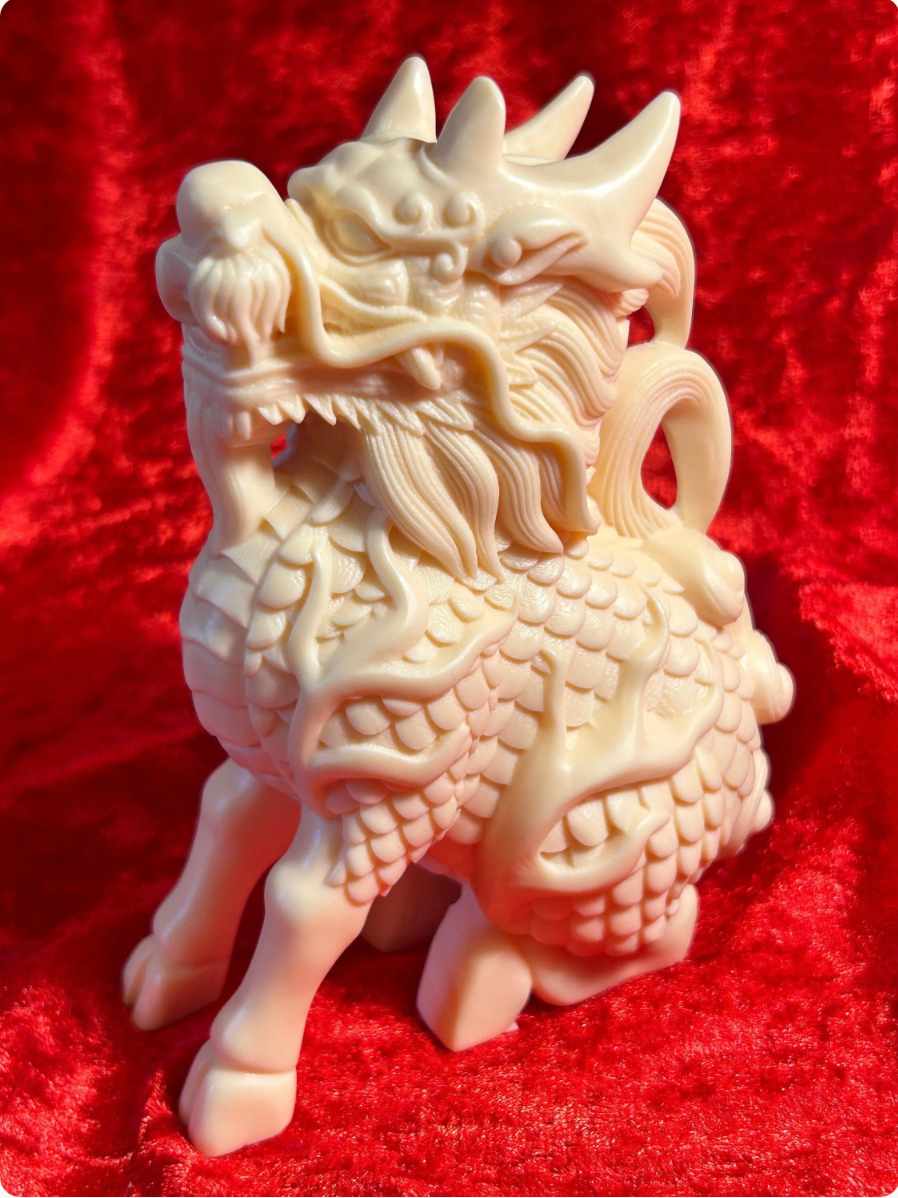 Cream-coloured 5-inch Chinese dragon figurine made from ivory nut composite, showing detailed scales, horns and whiskers against a red velvet background.