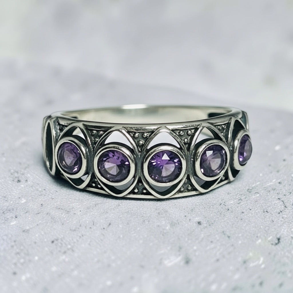 Celtic Dragon Jewellery adjustable sterling silver ring with cut-out design and five bezel-set amethyst gemstones.