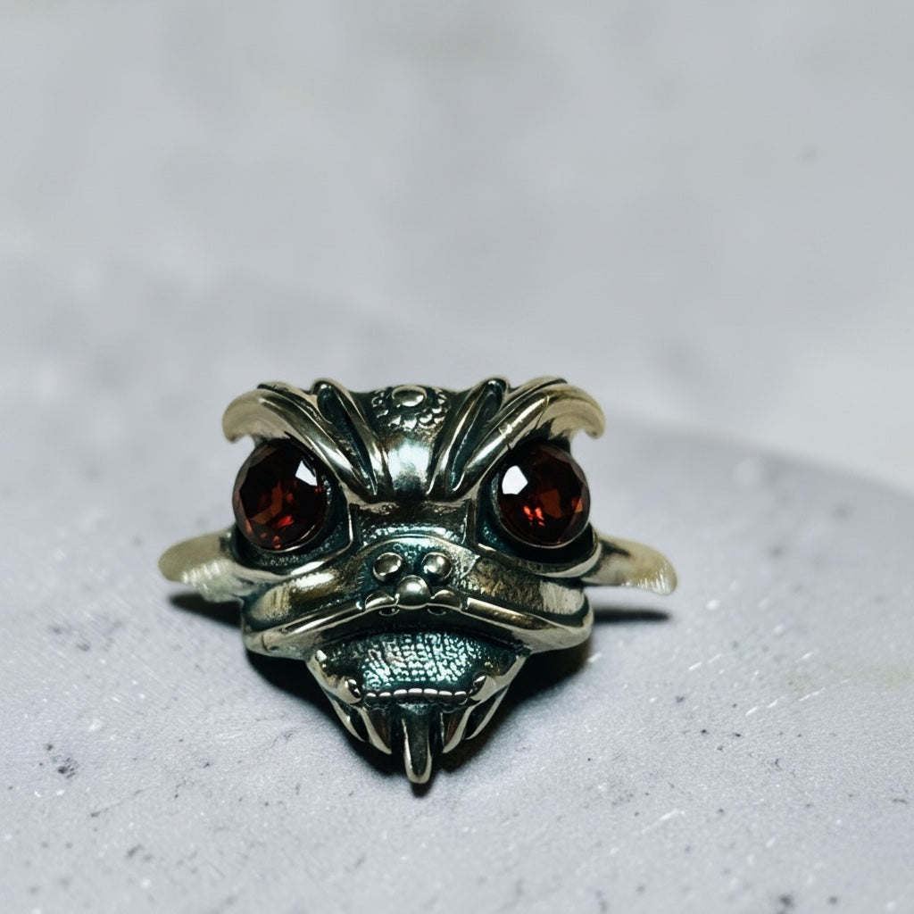 Celtic Dragon Jewellery sterling silver adjustable ring with faceted garnet eyes, oriental lion design.