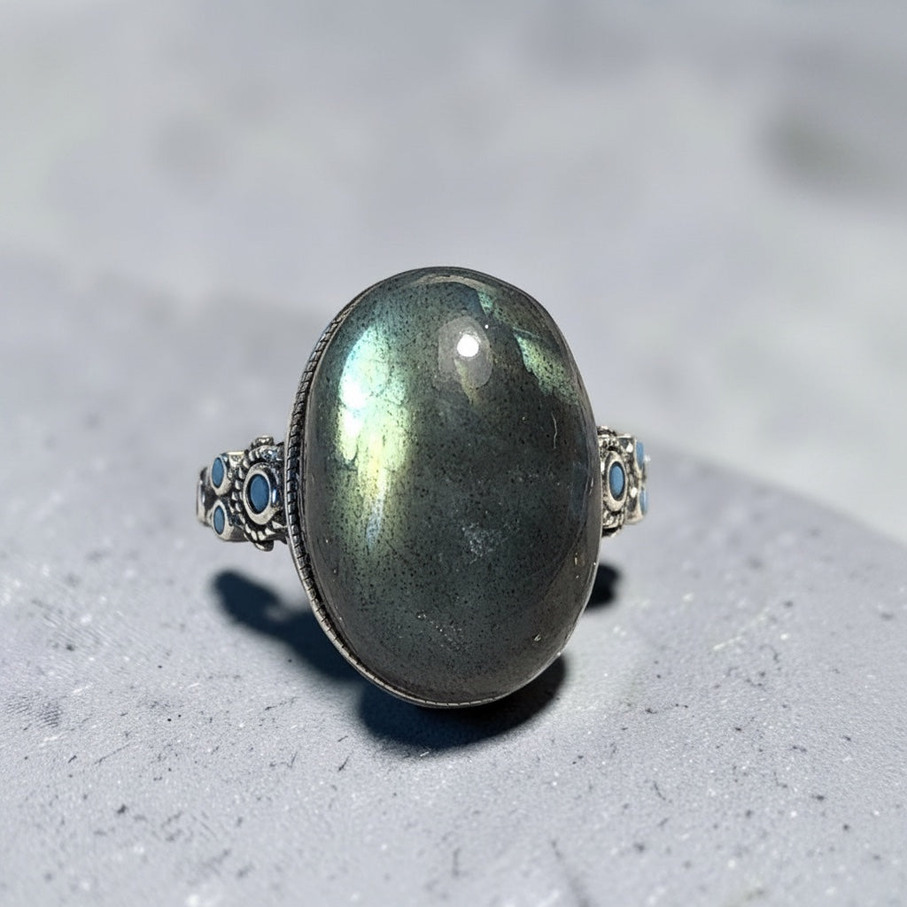 Celtic Dragon Jewellery adjustable 925 silver ring with oval labradorite stone showing blue and gold flashes, and small blue stones.