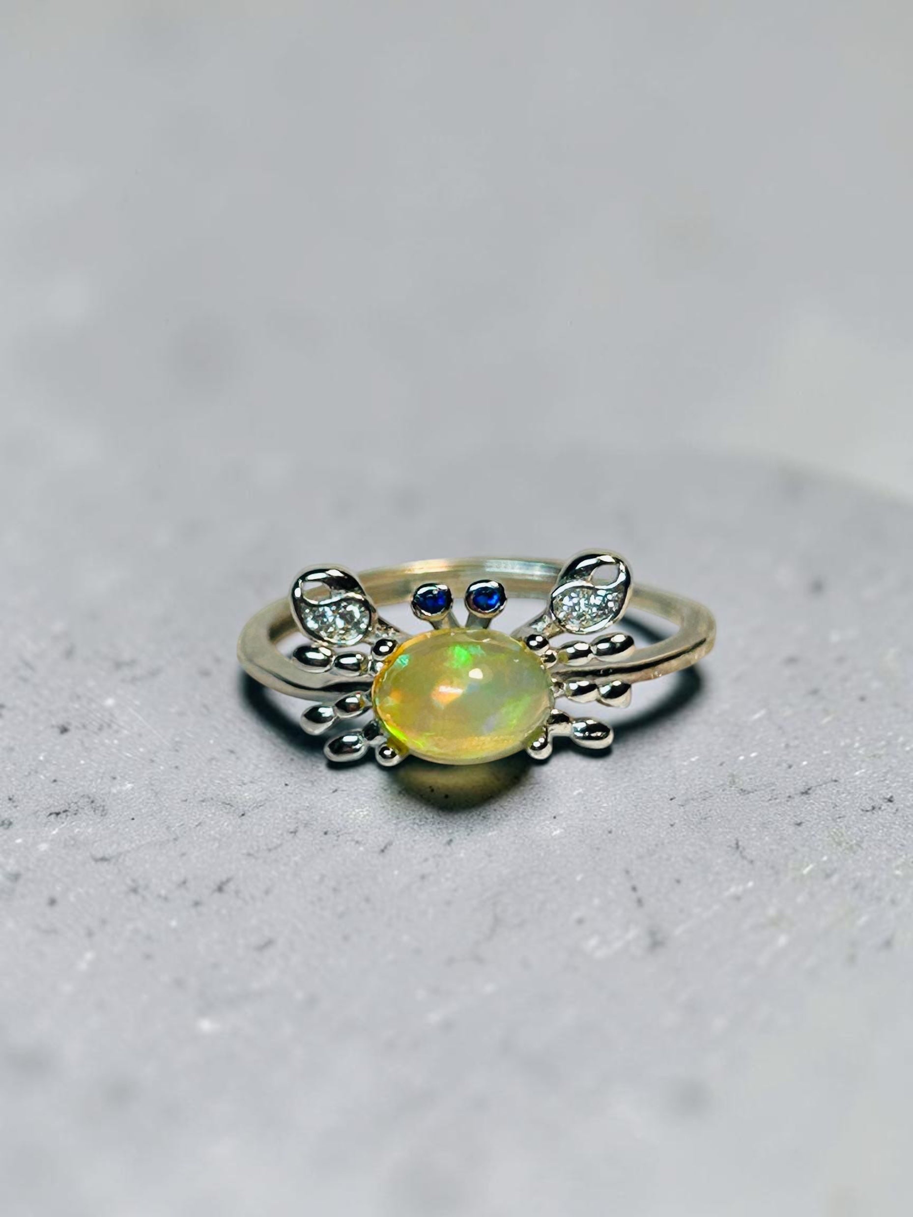 Celtic Dragon Jewellery sterling silver adjustable crab ring with opal, CZ eyes and clear CZ pincers.