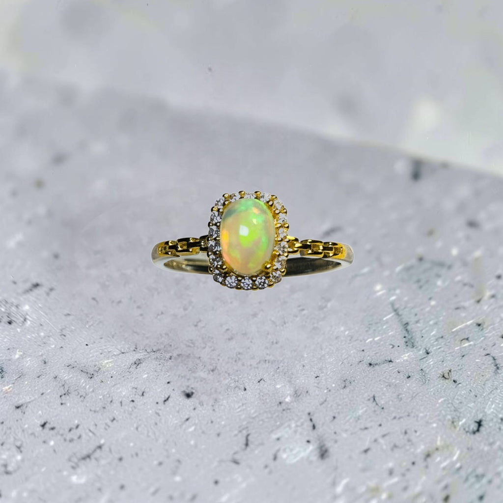 Celtic Dragon Jewellery 925 sterling silver adjustable ring with oval rainbow opal surrounded by CZ stones and 18ct gold plated links.