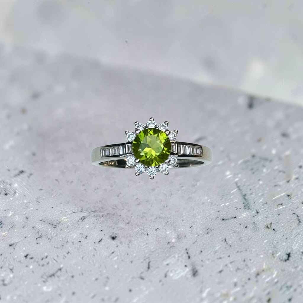 Celtic Dragon Jewellery adjustable 925 silver ring with a round peridot center and surrounding CZ accents.
