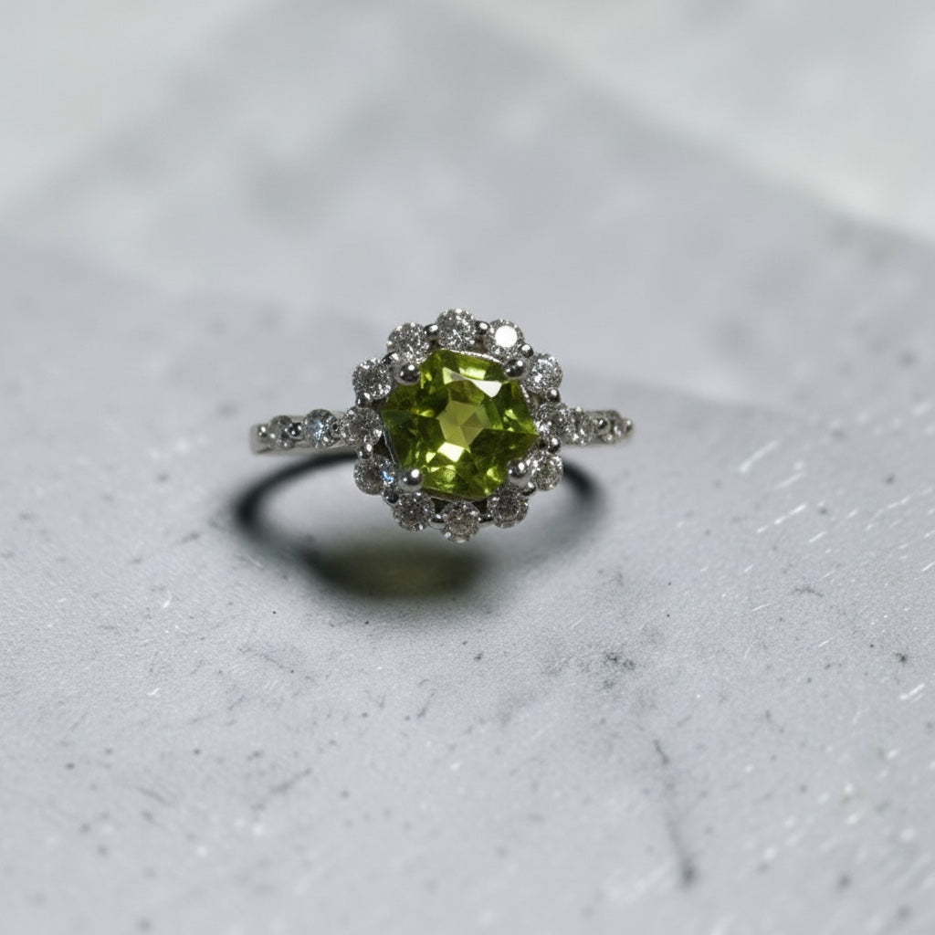 Celtic Dragon Jewellery adjustable sterling silver ring with a central peridot gemstone surrounded by CZ stones.