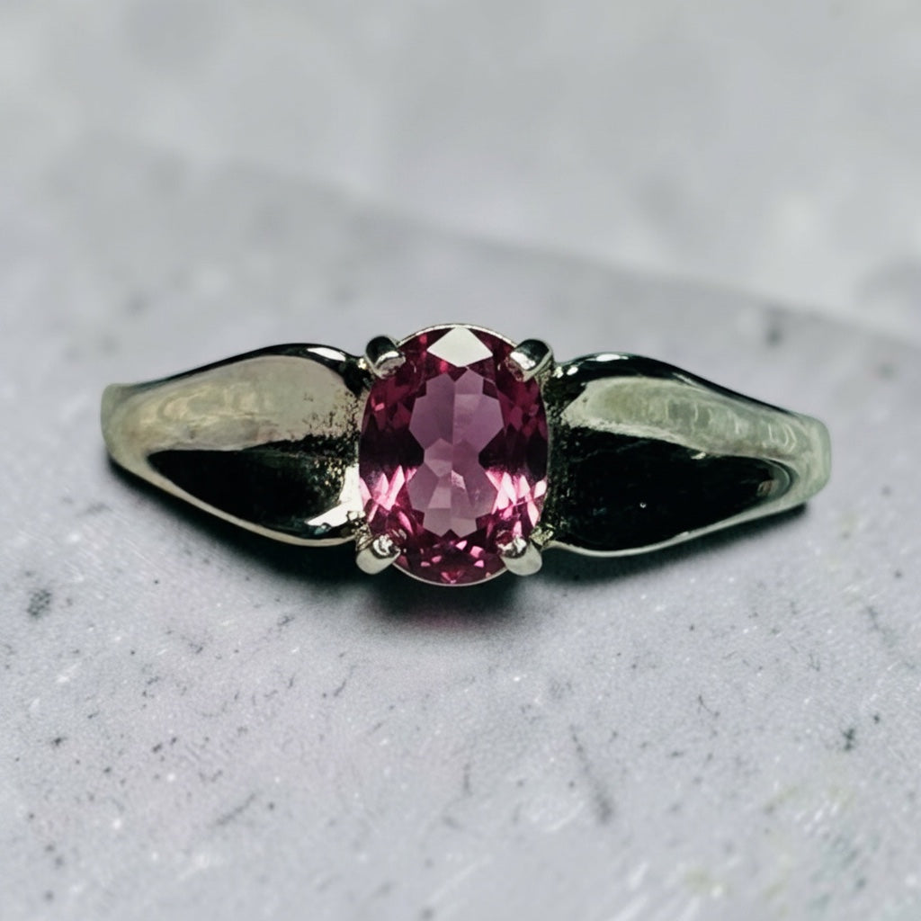 Celtic Dragon Jewellery adjustable 925 silver ring with oval purple garnet gemstone and dragon wing design.