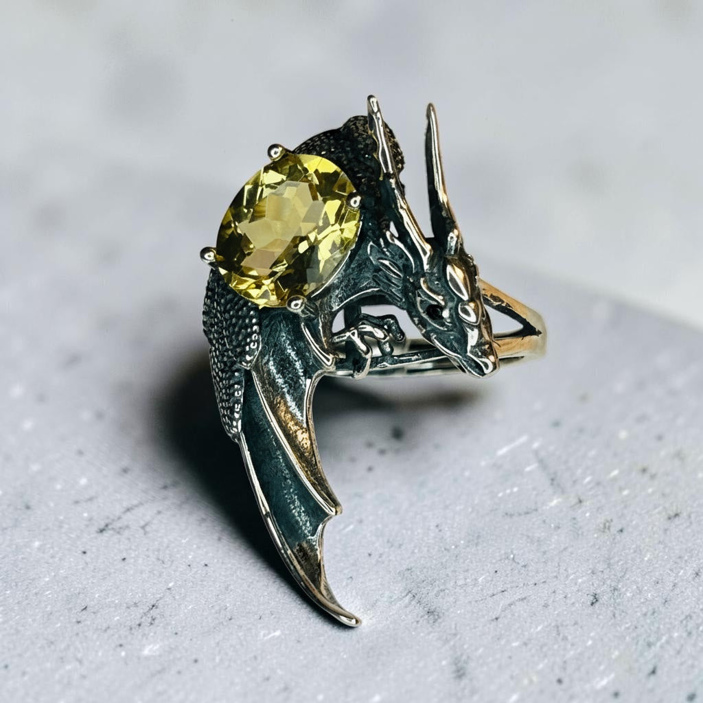Celtic Dragon Jewellery 925 sterling silver ring with a large oval faceted citrine gemstone and black spinel eyes. Adjustable band.