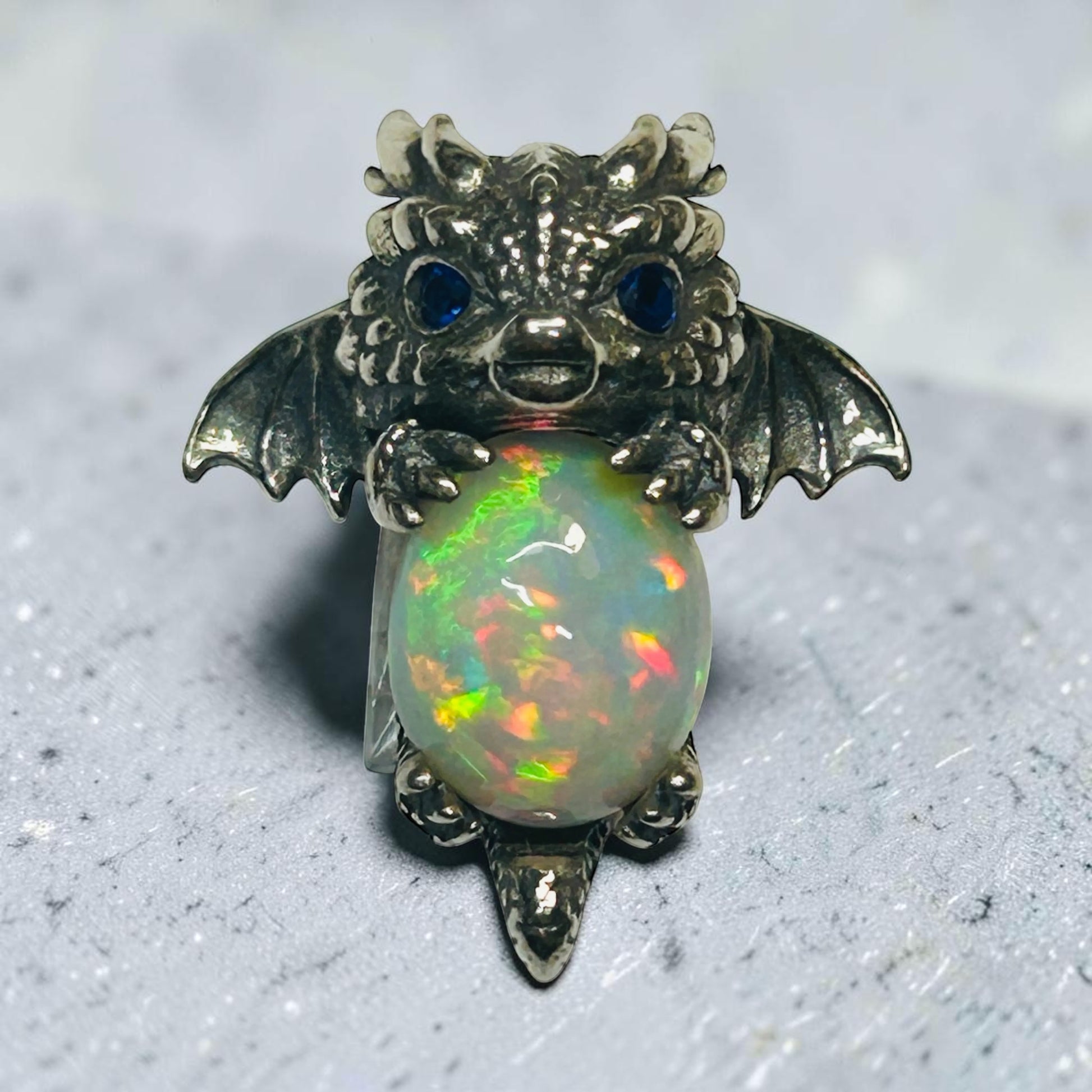 Celtic Dragon Jewellery sterling silver baby dragon pendant with vibrant opal and blue cz eyes.