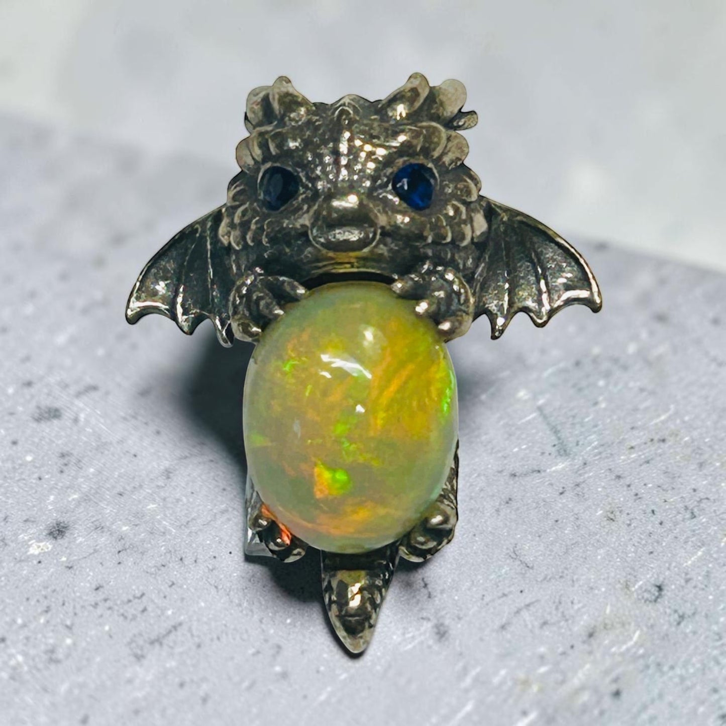 Celtic Dragon Jewellery sterling silver baby dragon pendant with vibrant opal and blue cz eyes.