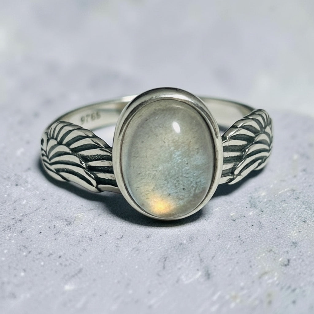 Celtic Dragon Jewellery adjustable sterling silver ring with oval labradorite and wing design. Features orange flashes and 925 stamp.