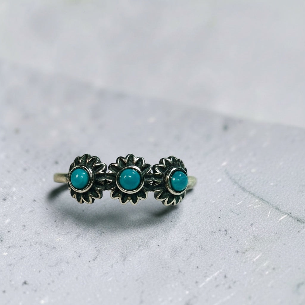 Celtic Dragon Jewellery adjustable 925 sterling silver ring with three turquoise gemstones in a rosette design and a feather accent.